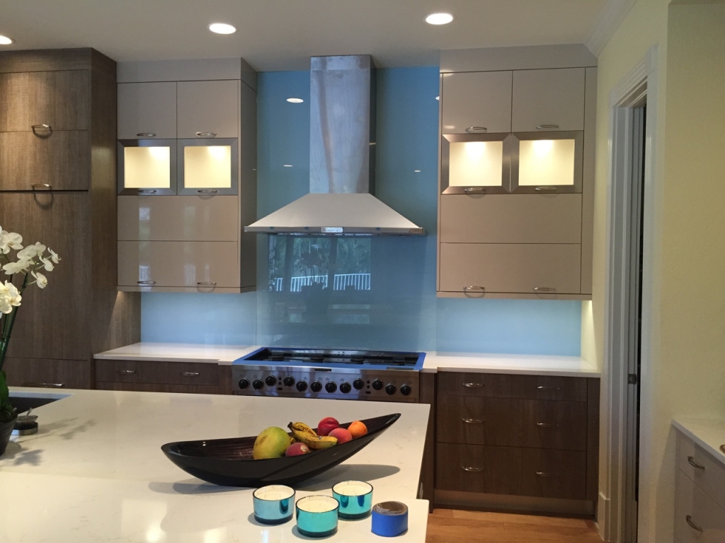 blue back painted glass backsplash in modern kitchen